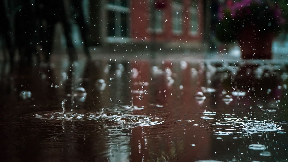 Raindrops on a window with blurred city view